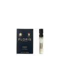 A 2ml vial of Floris London's Jermyn Street Eau de Parfum is elegantly displayed next to its sleek black and gold box.