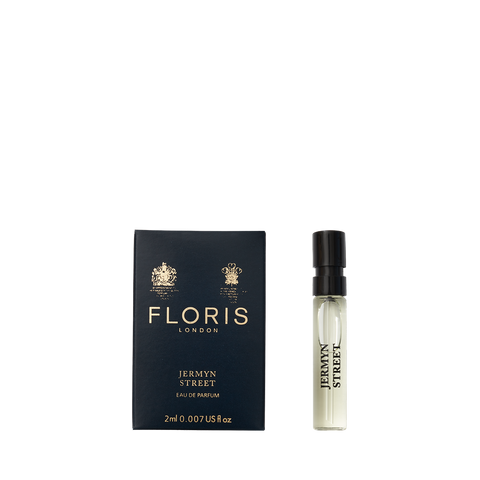 A 2ml vial of Floris London's Jermyn Street Eau de Parfum is elegantly displayed next to its sleek black and gold box.