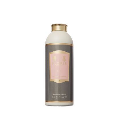 A 100g cylindrical bottle of Floris London's Lily-Fragrance Powder, with a pink label and gold accents, delivers a lily-floral aroma.