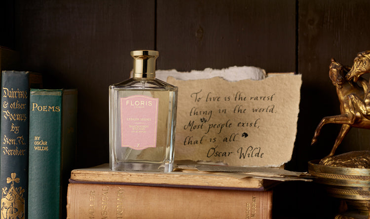 A bottle of Floris London Malmaison Encore, sat on a pile of books and next to an extract of Oscar Wilde