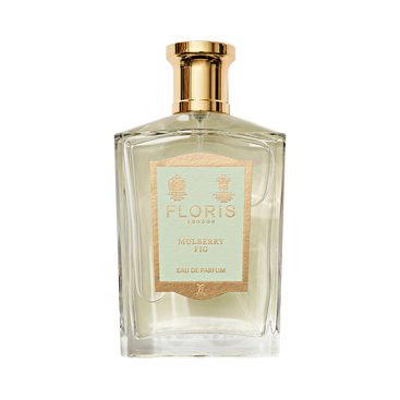 Clear glass perfume bottle with gold cap, labeled "Mulberry Fig - Eau de Parfum" by Floris London, exuding a floral amber fragrance.