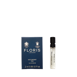 Floris London's Mulberry Fig, a floral amber eau de parfum, is available in a 2ml sample bottle next to its elegant navy box.
