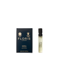 A perfume sample bottle sits next to a navy Floris London box labeled "Neroli Voyage - Eau de Parfum," exuding the scent of neroli and warm amber.