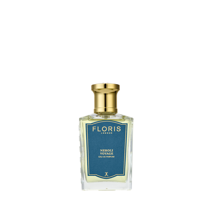 A clear glass perfume bottle with a gold cap, labeled “Floris London Neroli Voyage - Eau de Parfum,” evokes citrus and marine notes on a blue background.