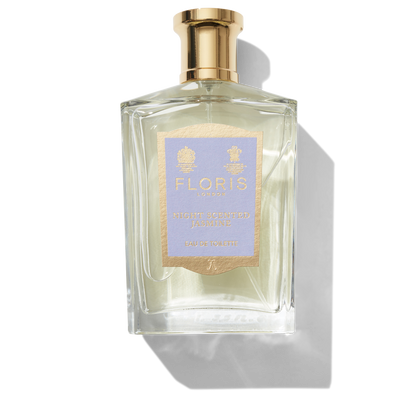 Clear glass bottle with gold spray top and light purple Night Scented Jasmine label