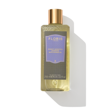 Clear 250ml bottle of Floris London's Night Scented Jasmine bath & shower gel with a gold cap, featuring floral heart and sandalwood base notes.
