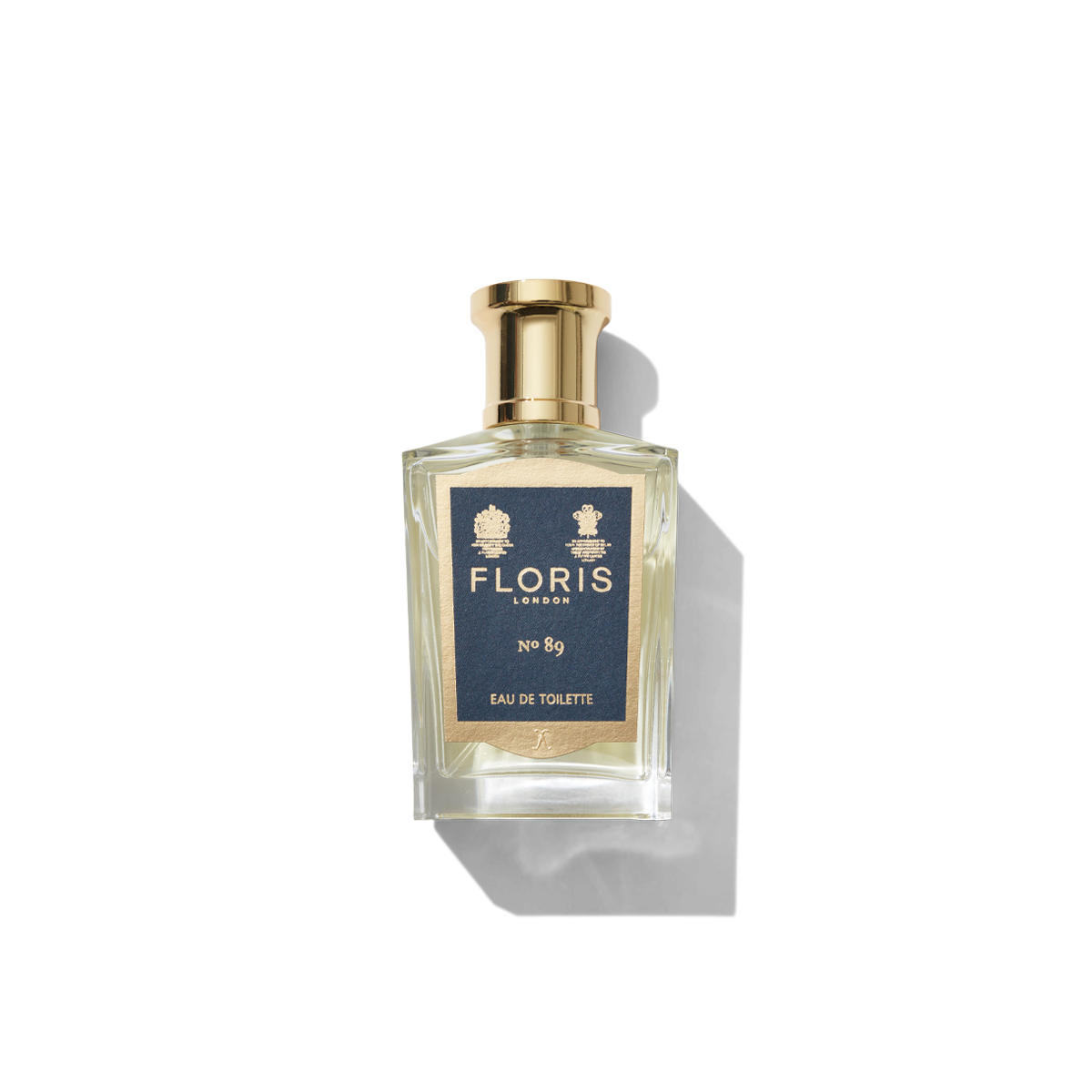 Medium Clear glass bottle with gold spray top and Navy No 89 label