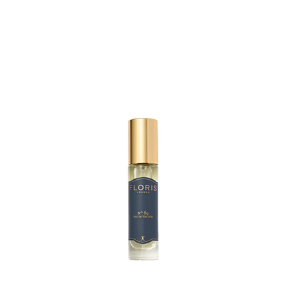 A small bottle of Floris London's No. 89 Eau de Toilette with a gold cap and dark blue label, ideal as a gentleman's signature scent.