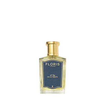 A Floris London No. 89 Eau de Toilette bottle, a signature gentleman's fragrance, has a gold cap and dark label on its clear glass.