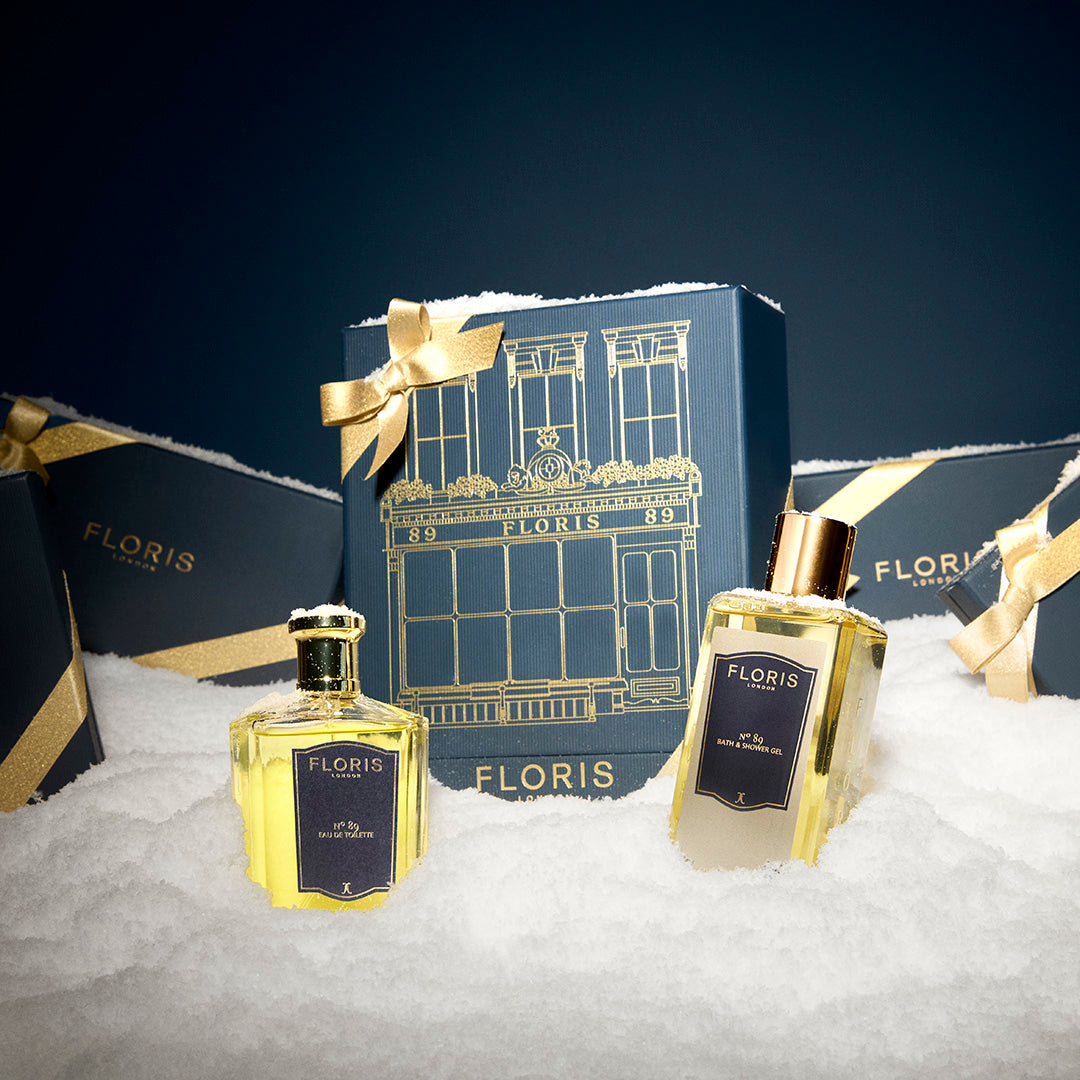 Two "The Icon | No. 89 Duo" Floris London UK perfume bottles with gold bows in gift boxes, displayed on artificial snow.
