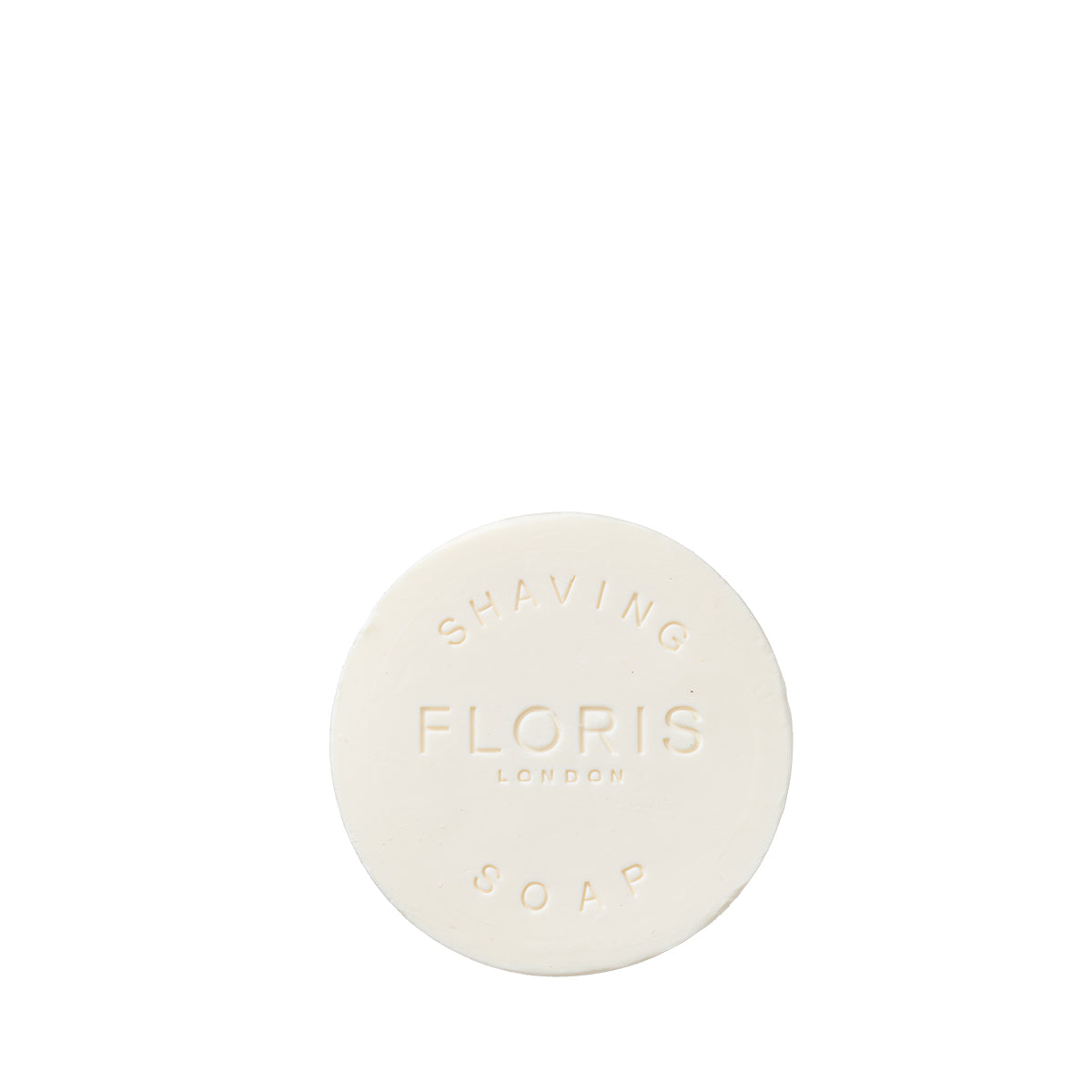 Round, triple-milled Floris London No. 89 shaving soap refill, embossed with "FLORIS LONDON," isolated on white.
