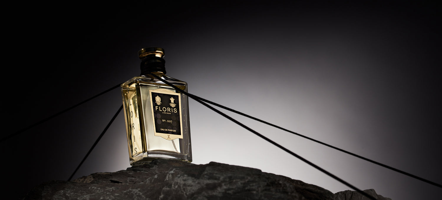 Floris London No.007 being held by Black lines on a black and white background