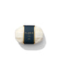 A bar of finely milled No. 89 Soap by Floris London, wrapped in white paper and adorned with a black label featuring gold accents, set against a white background.