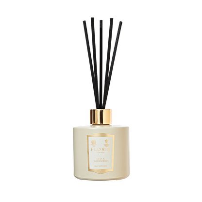 Floris London's Oud & Cashmere Reed Diffuser features a white diffuser with black reeds and a gold cap, blending luxurious Oud and Cashmere scents.