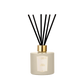 A Floris London Oud & Cashmere reed diffuser in beige with a gold cap and black reeds, shown on a plain white background.
