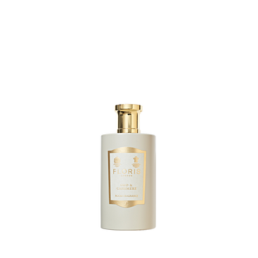 Floris London's "Oud & Cashmere" room fragrance in a white bottle with a gold label and cap exudes luxury.