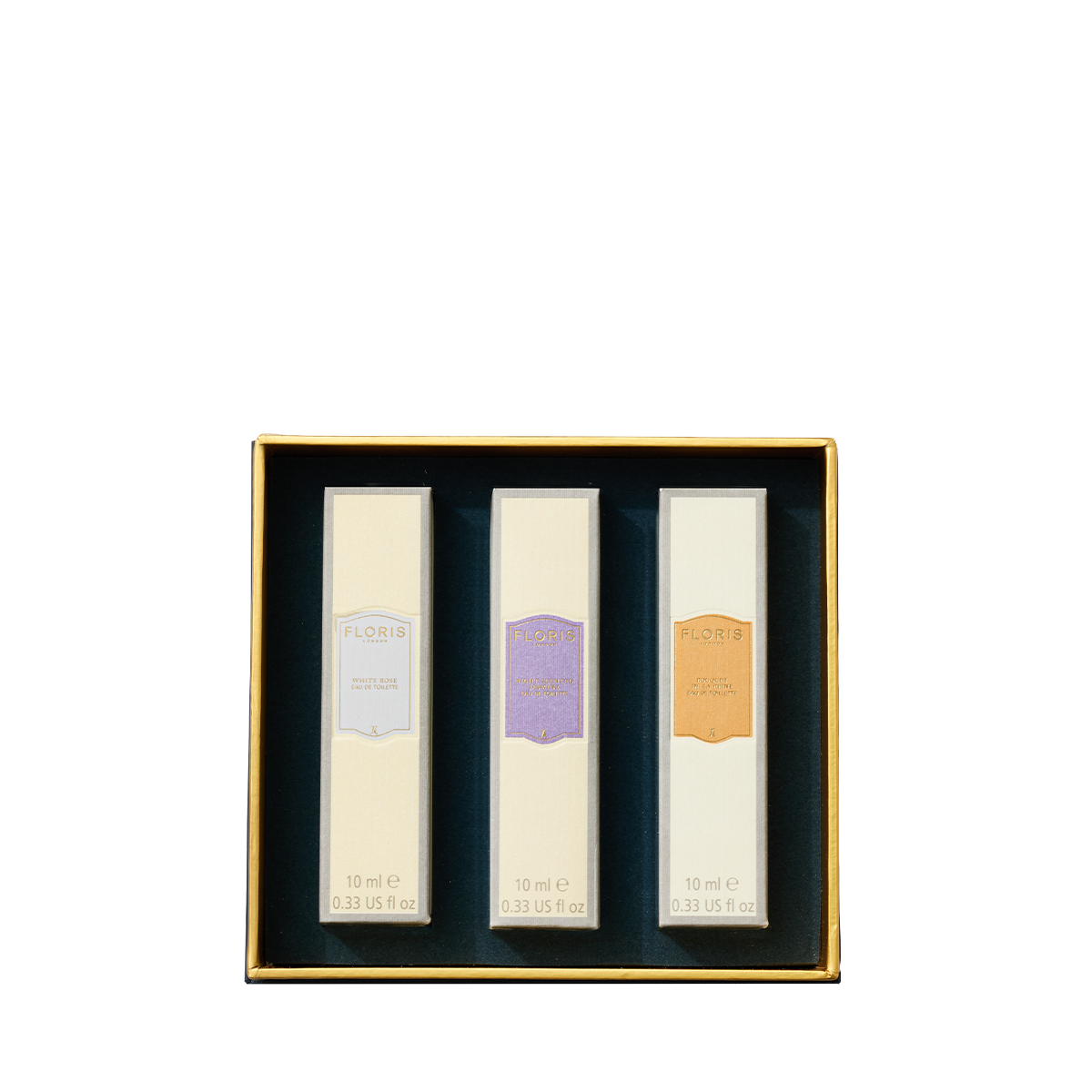 A gold box with three labeled floral perfumes from Floris London—Perfumer's Trilogy: For Her—delicate fragrances arranged for her enjoyment.