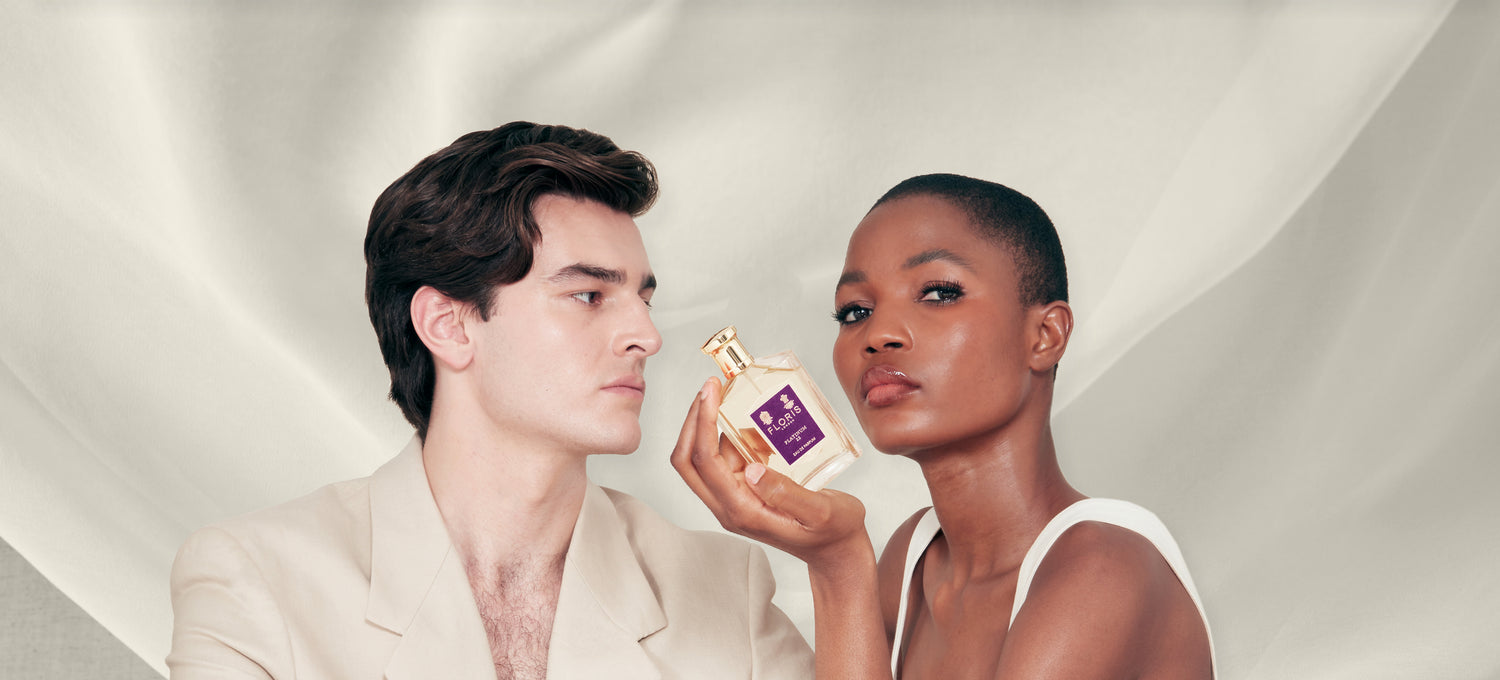 Two models, one lady and one man, holding a bottle of Platinum 22 eau de parfum