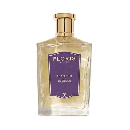 A clear glass bottle of Platinum 22 - Eau de Parfum by Floris London, featuring a gold cap and purple label—an elegant vegan fragrance.