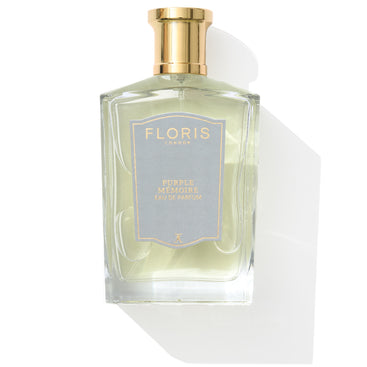 Sophisticated fragrance in a perfume bottle with a gold cap and blue label, "Purple Mémoire - Eau de Parfum" by Floris London UK, exuding English charm.