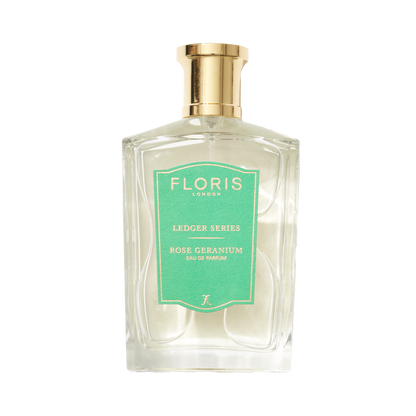 Transparent bottle with a gold cap, featuring a green "Floris London UK Rose Geranium" label, infused with cedarwood notes.