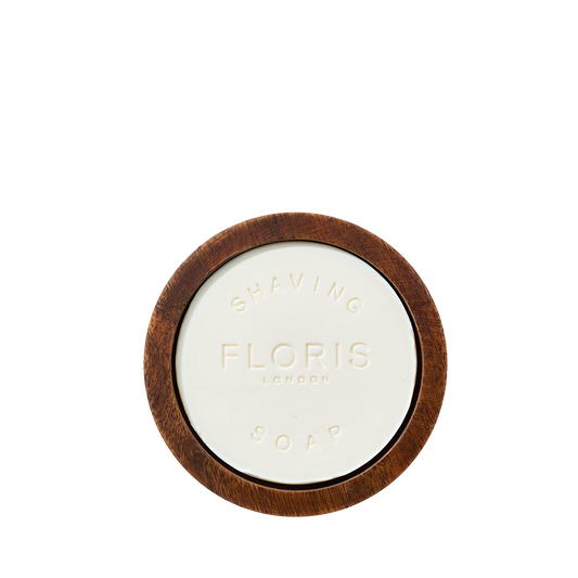 Floris London Santal Shaving Soap, embossed with the brand, sits in a classic wooden bowl, viewed from above against a white background.
