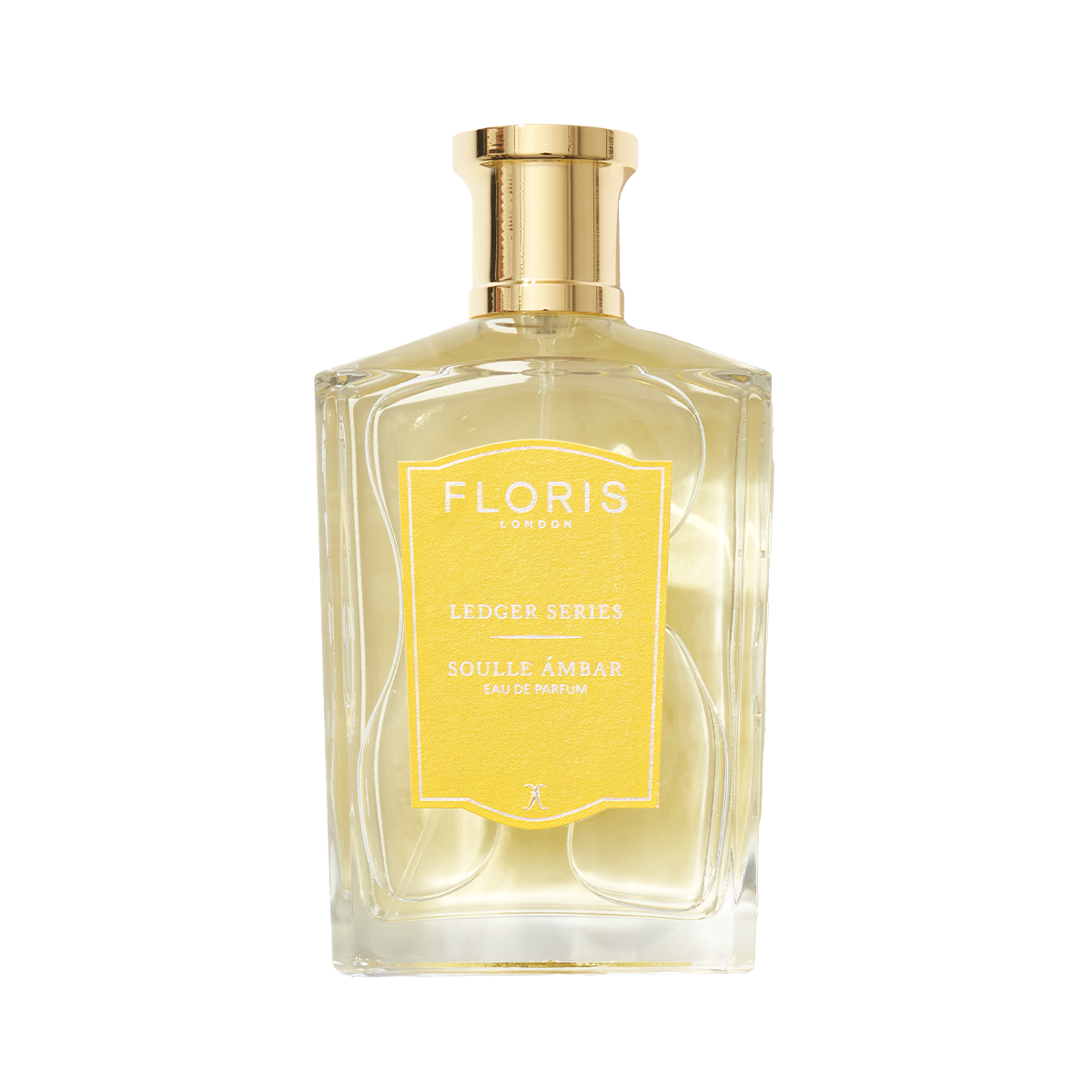 Soulle Ámbar perfume in a clear amber glass bottle with a gold cap and a yellow rectangular label.