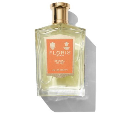 Clear glass bottle with gold spray top and Orange Special No 127 label