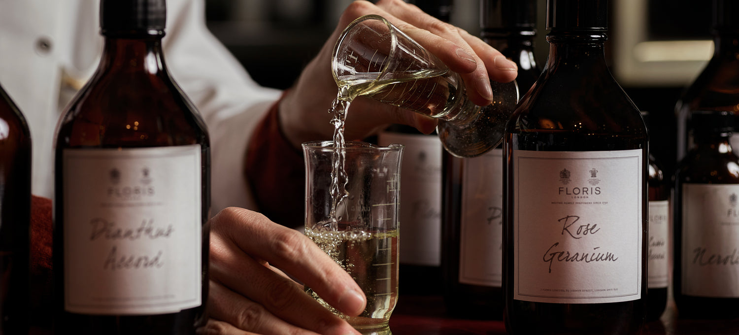 Perfume being poured into glass vials at Floris London 