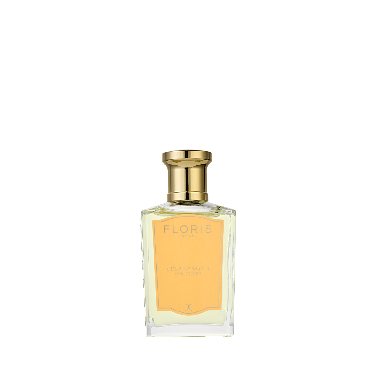 A clear glass bottle with a gold cap, labeled “Floris London Stephanotis Bath Essence,” evokes delicate notes of orange blossom.