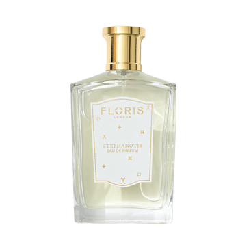 A clear glass bottle of Floris London UK Stephanotis | Limited Edition perfume, with a gold cap, white label, and a delicate floral scent.