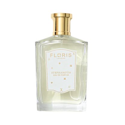 A clear glass bottle of Stephanotis - Eau de Parfum | Limited Edition by Floris London UK, featuring a gold cap with hints of sandalwood and fresh orange blossom.