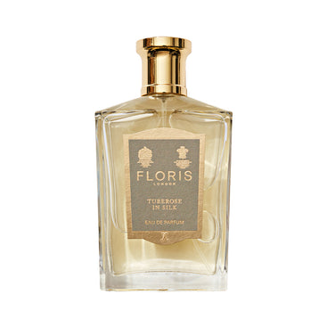 The luxurious "Tuberose in Silk" perfume by Floris London comes in a clear rectangular bottle with a gold cap.