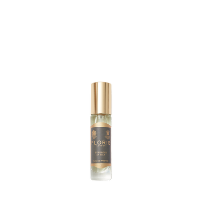A small bottle of Floris London's "Tuberose in Silk" Eau de Parfum with a golden cap and beige-dominant label exudes rich jasmine notes.