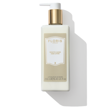 a clear bottle with a white label saying white rose on it 