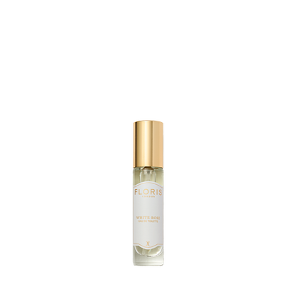 A perfume bottle with a gold cap labeled "White Rose - Eau de Toilette" by Floris London captures the timeless vibrancy of velvet roses, on a white background.