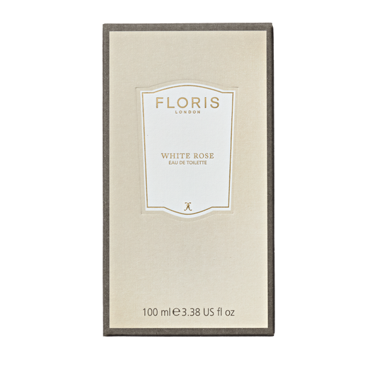A beige Floris London box labeled "White Rose - Eau de Toilette" features notes of velvet roses and warm amber, containing 100 ml (3.38 US fl oz).