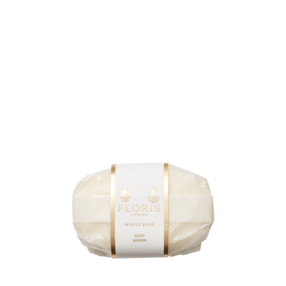 Circular white "White Rose Soap" by Floris London, with gold accents and a creamy shea butter-enriched lather.
