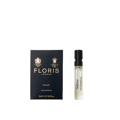A deep blue box of Floris London Wilde - Eau de Parfum sits beside a small clear spray vial, representing freedom and individuality.